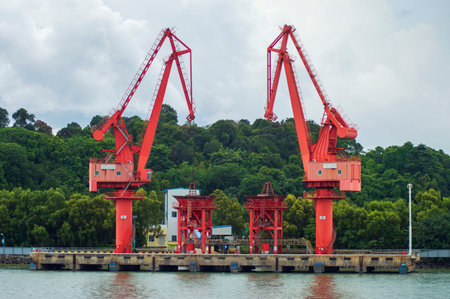 Batam, Indonesia. 7 July 2024. Grab crane, a tool used for loading and unloading cargo from ships.の写真素材