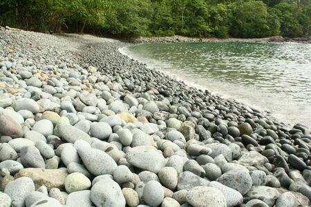 The rock beach at green bay Banyuwangiの写真素材