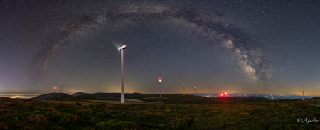 Panoramic view of the Milky Way over a windmill.の写真素材