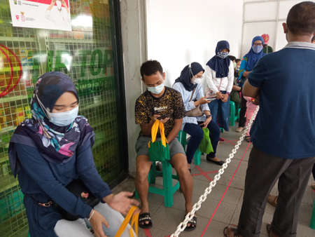 queues of buyers wearing masks at supermarkets