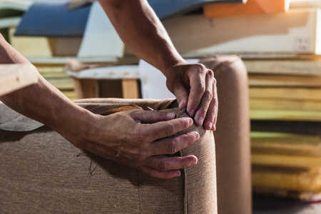 a man cutting a piece of foam rubberの写真素材
