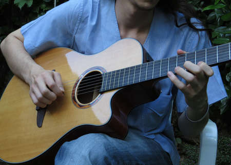 Man playing acoustic guitarの写真素材