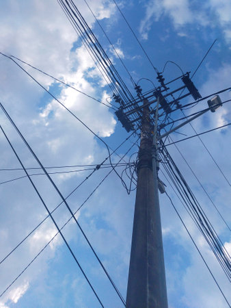 electricity post with blue sky and white cloud background, Thailand.の写真素材
