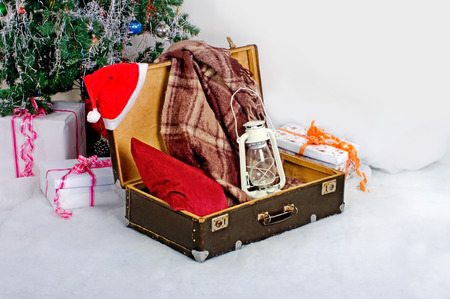 Christmas new year card suitcase Santa Claus with giftsの写真素材