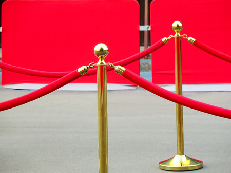 Red carpet entrance with golden stanchions and ropes. Celebrity nominees to premiere. Stars on the festive awarding of prizes awardsの写真素材