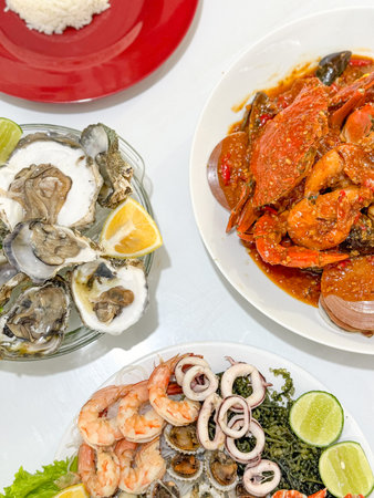 seafood plate with fresh shrimp squid oyster and crab with seafood sauce chili lemon lime