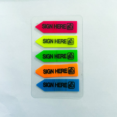 set of sign here stickers in various colors arranged on a white background