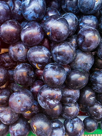 close up and freshly picked plum fruit stacked as food backgroundの写真素材