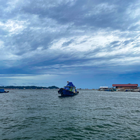 Serene fishing boat on calm waters under a dramatic stormy sky, evoking a sense of peaceful maritime...