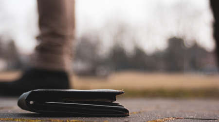 Black wallet on street