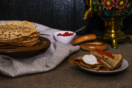 thin pancakes with red caviar on gray canvas napkin. The concept of the Russian carnival Maslenitsa.の写真素材