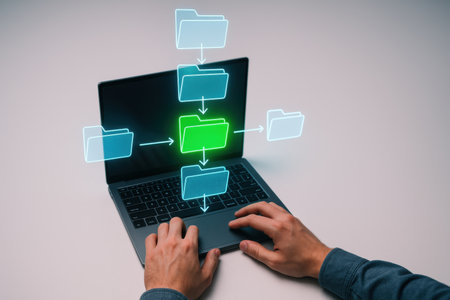 Close up of hands using laptop with green folder icon on the screenの素材