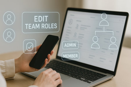 Woman using smartphone at table with laptop and social media icons on screenの素材