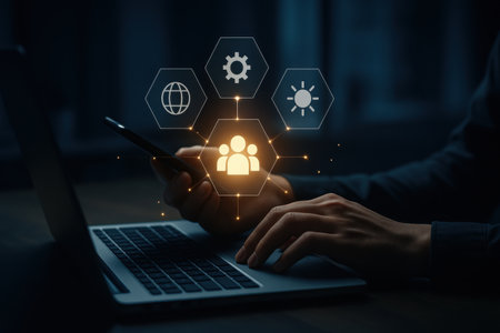 businessman working with mobile phone and laptop computer in dark office at nightの素材