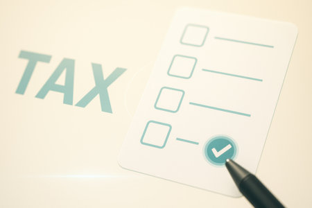 Tax concept with check boxes and a pen on a white background.の素材