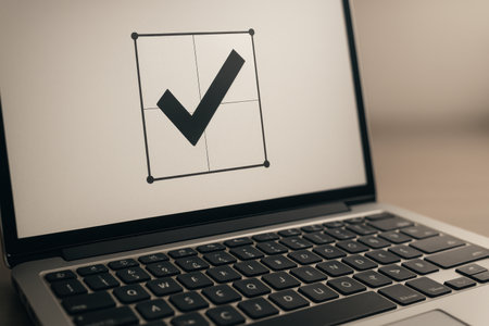 Close up view of a laptop with a check mark icon on the screenの素材