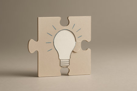 Idea concept with light bulb and jigsaw puzzle on grey backgroundの素材