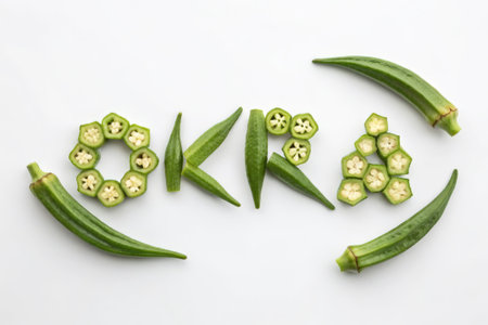 Word okra written with fresh raw okra vegetable on white backgroundの素材