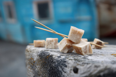 Sugar cubes and wooden chopsticks on wooden table, closeupの素材