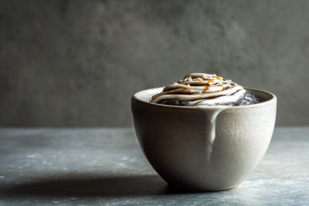 Coffee with caramel in a ceramic cup on a gray backgroundの素材