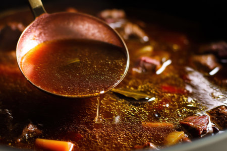 Beef soup in a pot with a spoon, close-upの素材