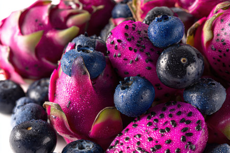Dragon fruit and blueberries on white background. Close-up.の素材