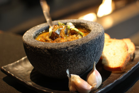 Goulash soup in a stone bowl on a dark background.の素材