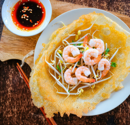 Thai fried noodle with shrimp in white plate on wooden tableの素材
