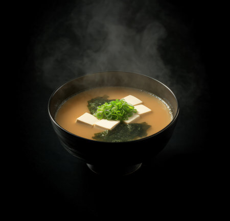 Japanese miso soup with tofu and seaweed on a black backgroundの素材