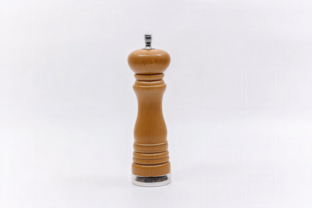 Wooden pepper mill isolated on white background, clipping path included.の素材