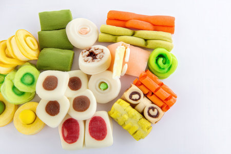 Colorful candies on white background. Top view. Copy space.の素材