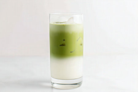 Green tea latte in a glass on the white table, stock photoの素材