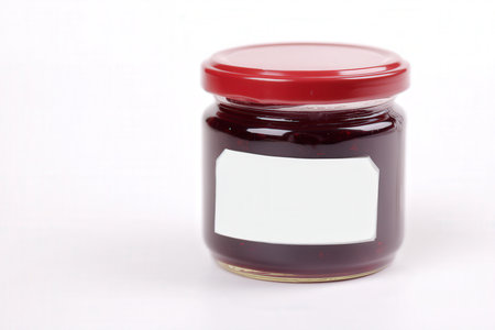 A jar of jam on a white background with space for text.の素材