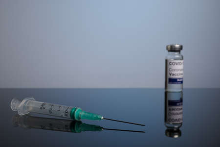Covid vaccine with inoculation syringe with copyspace. Covid-19 vaccination set with syringe and inoculation vial. Covid treatment photo for healthcare promotion.の写真素材