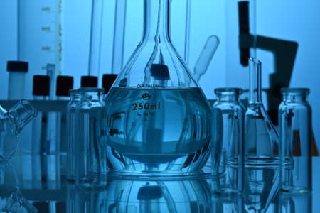 Chemical glassware equipment in science laboratory. Glass flasks, test tubes and cylinder equipment...