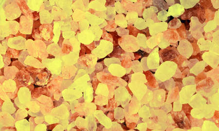 Amber stones for backgrounds. Closeup baltic amber stones lay on a flat surface. Rectangular area of yellow crystals. Natural gemstone minerals lie in rectangle background. Photo of jewelery stones.の写真素材