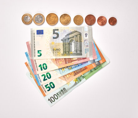 Nominals of Euro banknotes and coins. Euro banknotes with different nominal costs. Samples of paper an metallic money from Europe. Real European currency bills and coins. Salary in EUR cash.の写真素材