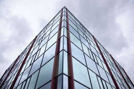 corner of office building with reflections of overcast skyの写真素材