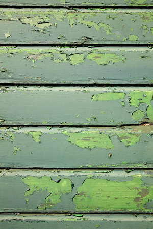 part of weathered old planks of green fencing or boardingの写真素材