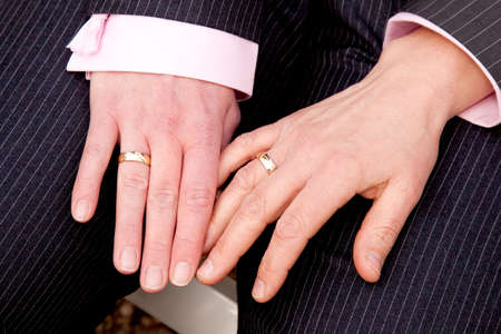 two female hands with wedding rings on homosexual weddingの写真素材