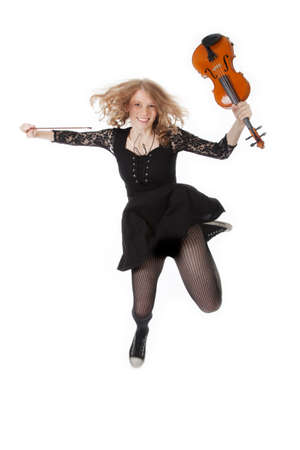 girl with violin jumping into the air against white backgroundの写真素材