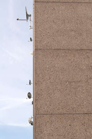 satellite dishes on apartment building and skyの写真素材