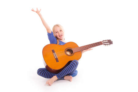 young happy girl with guitar against white backgroundの写真素材