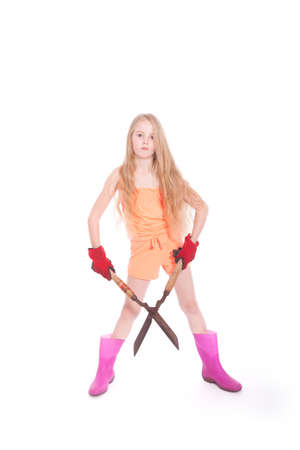 young blond girl with garden shears in studio against white backgroundの写真素材