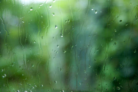 windshield during heavy rain with green out of focus backgroundの写真素材