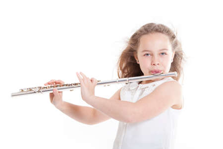 young girl playing the flute against white background in studioの写真素材