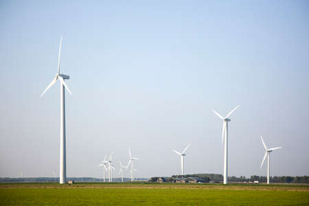 wind turbines in the green fields of the province Flevoland in the Netherlandsの写真素材