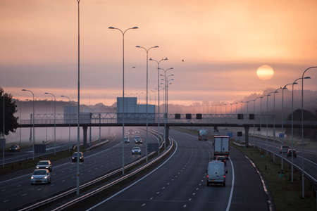 fog and rising sun in the morning on highway A28 near Utrecht De Uithofのeditorial素材
