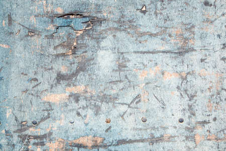 abstract background consisting of weathered board with old blue paint and boltsの写真素材