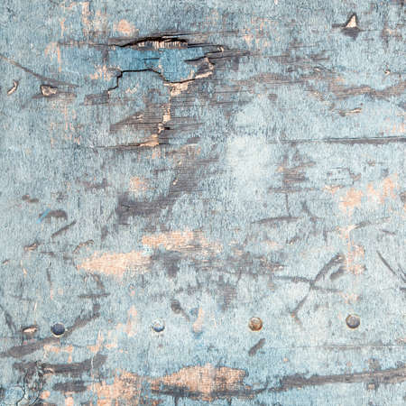 abstract background consisting of weathered board with old blue paint and boltsの写真素材